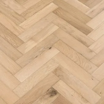 A detailed view of small herringbone flooring in a champagne finish. The flooring pieces display a light, golden hue with gentle variations, adding a touch of elegance and warmth.