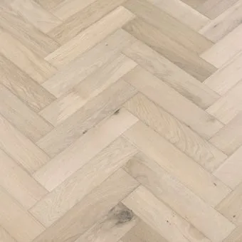A close-up image of small herringbone flooring in a granite finish. The pattern features a mix of light and dark grey tones, creating a sophisticated and modern look.