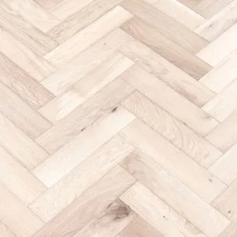 A close-up image of small herringbone flooring in a snow finish. The pattern features a mix of white and light grey tones, creating a clean and crisp look.