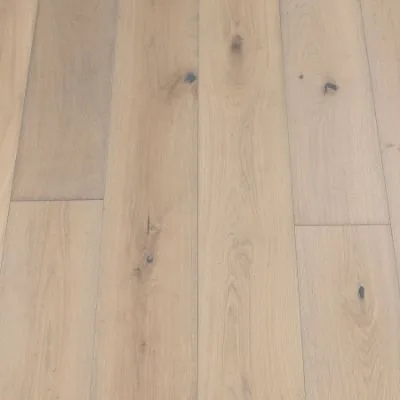 An image of shale plank flooring. The planks exhibit a dark grey colour with natural wood grain textures, offering a sleek and contemporary appearance.