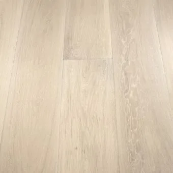 A close-up image of wide wooden planks in a light ivory tone. The smooth surface and soft, pale colour give the floor an airy and spacious feel. The light ivory shade highlights the natural grain of the wood, providing a modern and minimalist aesthetic.