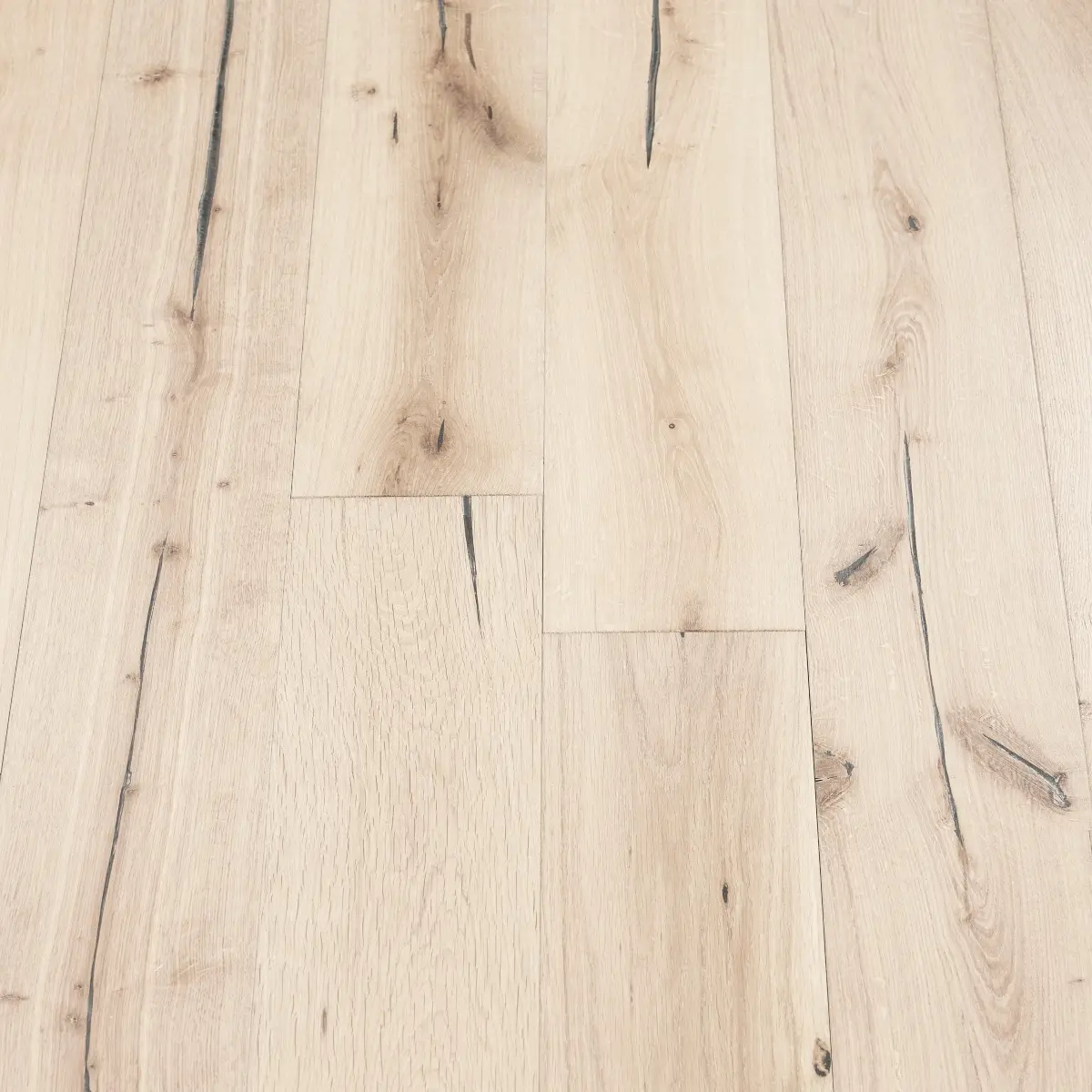 Alpine Distressed Wood Flooring: A photograph displaying distressed alpine wood flooring with whitewashed tones and distressed textures, evoking a sense of rustic elegance.