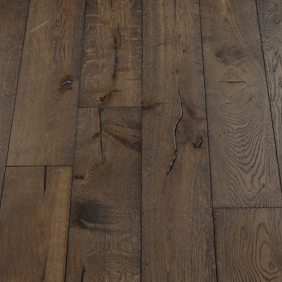 Black Olive Distressed Wood Flooring: An image displaying distressed black olive wood flooring with deep, rich brown hues and weathered textures, adding warmth and character to any space.