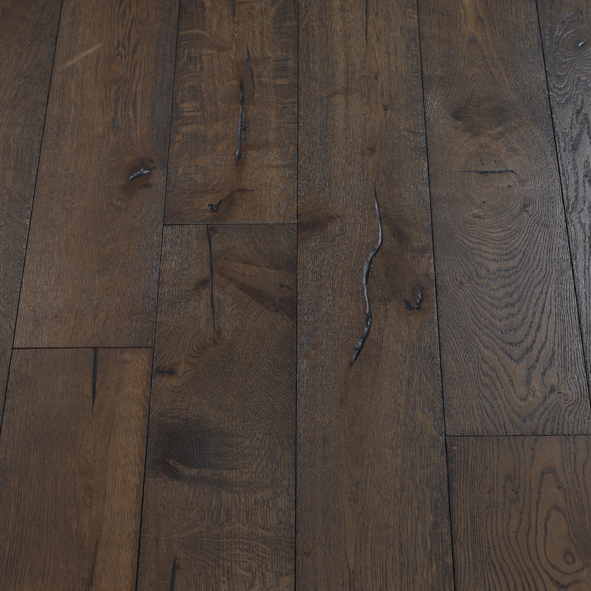 Distressed Carbon Flooring: A view of distressed carbon flooring, characterized by its deep charcoal-gray colour with distressed textures, offering a modern and sleek aesthetic.