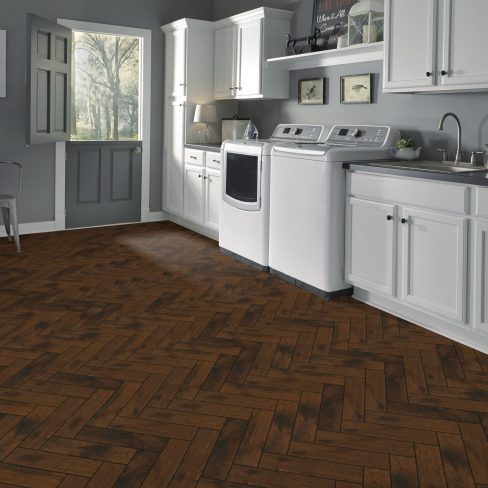 A stylized graphic symbolizing golden-toned herringbone flooring, possibly serving as a visual reference for selecting warm-toned wood options.