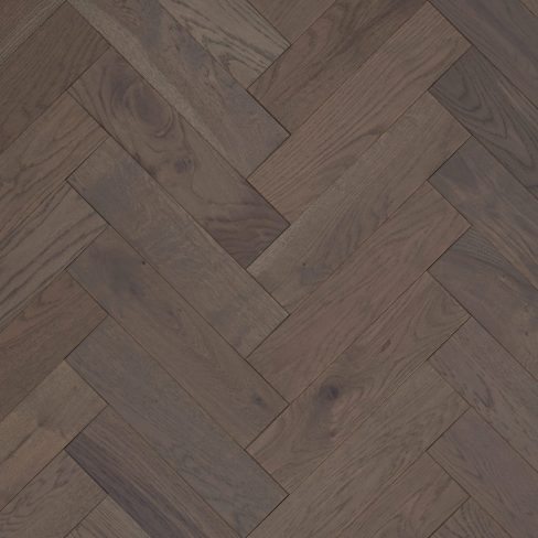 A high-resolution image of Jordan Woodfloors’ Light Grey herringbone flooring, featuring soft, neutral grey tones with subtle wood grain details, arranged in a herringbone pattern with a Brushed & UV Oiled finish for a smooth and elegant look.