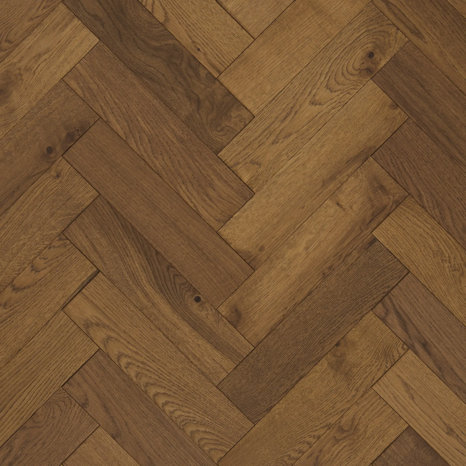 A high-quality image of Jordan Woodfloors’ Smoked herringbone flooring, characterized by deep, smoky brown tones with natural wood grain patterns, finished with Brushed & UV Oiled for a luxurious and long-lasting effect.