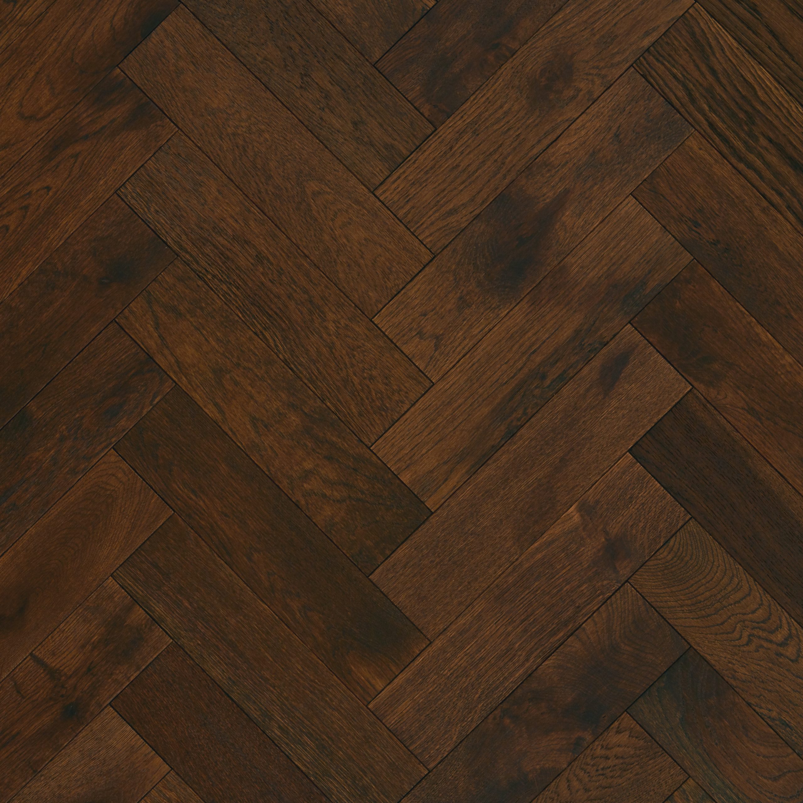 A complete view of the Old English Herringbone flooring, characterized by its classic, medium-brown tones and UV-oiled finish, evoking a timeless and elegant aesthetic.