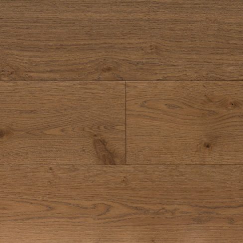 A top-down view of Universal Clic Harvest Oak laminate flooring swatch, featuring warm golden-brown tones reminiscent of freshly harvested oak. The visible wood grain adds depth and character, making it a perfect choice for classic and rustic interiors.