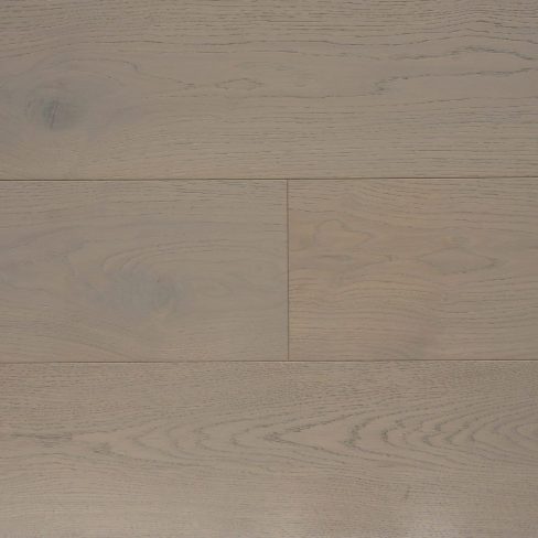 A top-down view of Universal Clic Platinum Oak laminate flooring swatch, featuring a light grey-toned oak finish. The wood grain pattern is finely detailed, with subtle knots and natural variations, offering a contemporary and elegant flooring option.